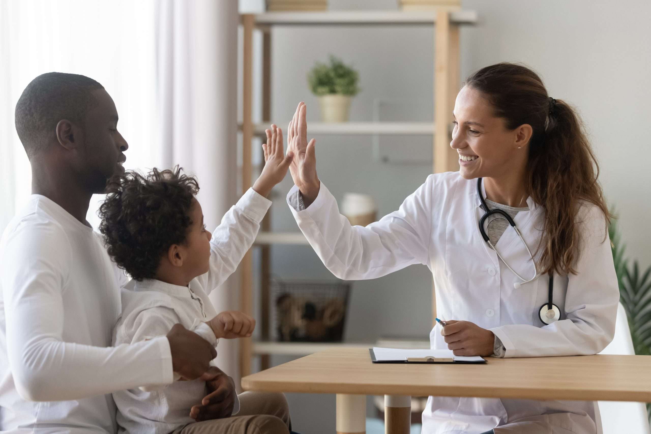 A Doctor comforts a child after an office visit